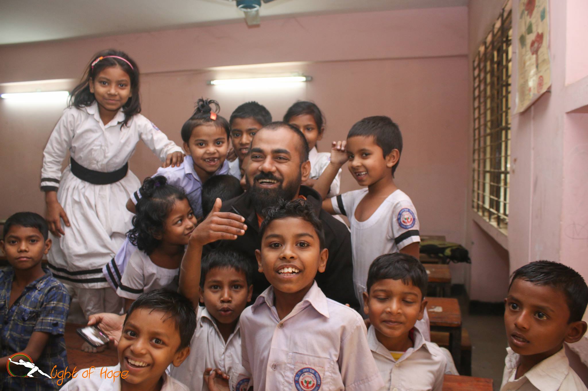 Waliullah Bhuiyan with school students of a primary school